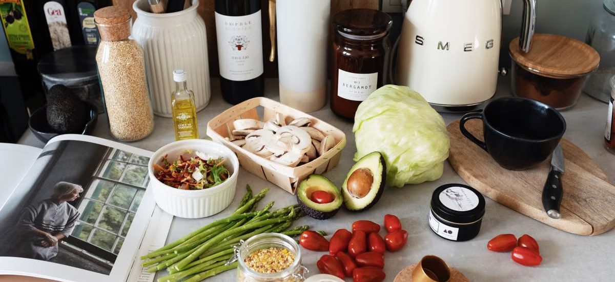 A variety of fresh ingredients and kitchen tools for preparing a healthy meal.