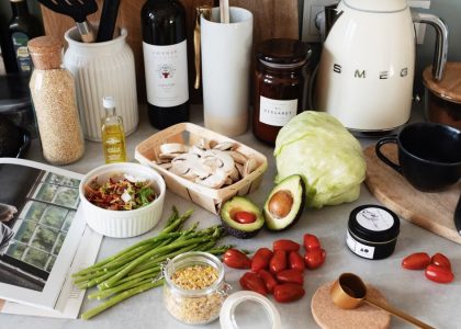 A variety of fresh ingredients and kitchen tools for preparing a healthy meal.