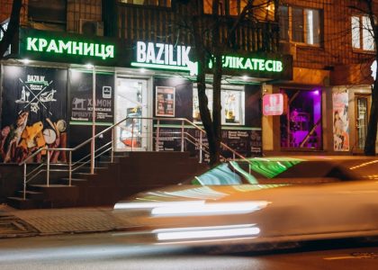 cars parked in front of store during night time